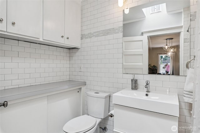 13257 4th Ave S, Burien, WA 98168 - bathroom with tile walls, vanity, toilet, and tasteful backsplash