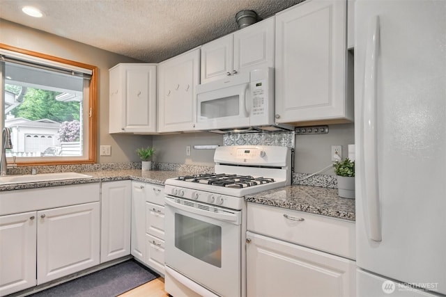 152 S 324th Pl Unit 65, Federal Way, WA 98003 - kitchen with white appliances, white cabinetry, a sink, and a textured ceiling