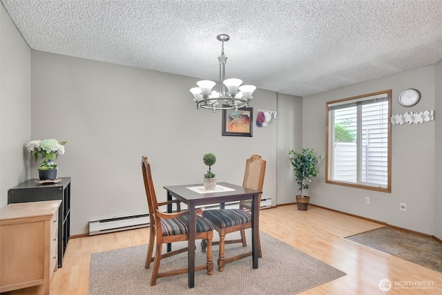 152 S 324th Pl Unit 65, Federal Way, WA 98003 - dining room with baseboard heating, a chandelier, light wood-style flooring, a textured ceiling, and baseboards