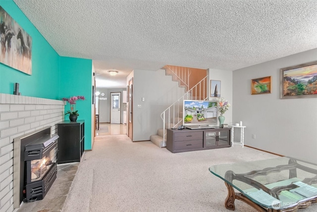 152 S 324th Pl Unit 65, Federal Way, WA 98003 - carpeted living room featuring a textured ceiling, stairway, baseboards, and a fireplace
