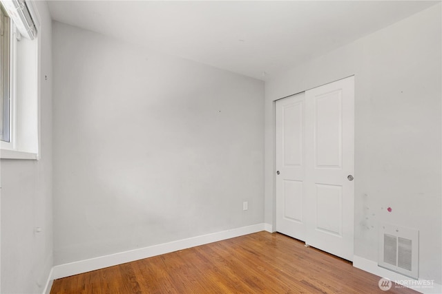 17004 11th Ave NE, Shoreline, WA 98155 - unfurnished bedroom with baseboards, light wood-style floors, and a closet