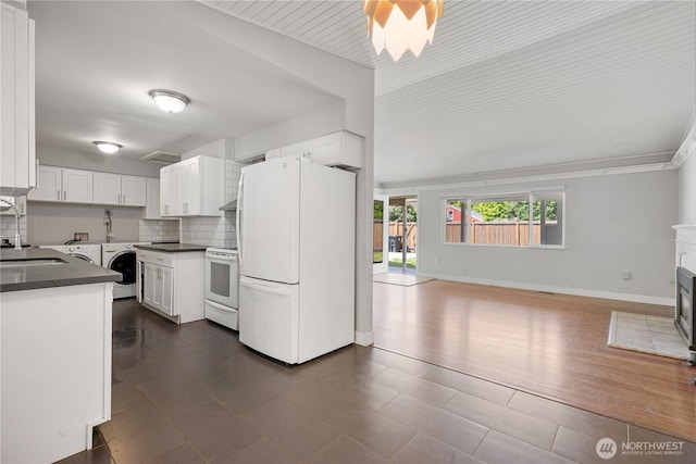 17004 11th Ave NE, Shoreline, WA 98155 - kitchen featuring white appliances, dark countertops, white cabinetry, open floor plan, and backsplash