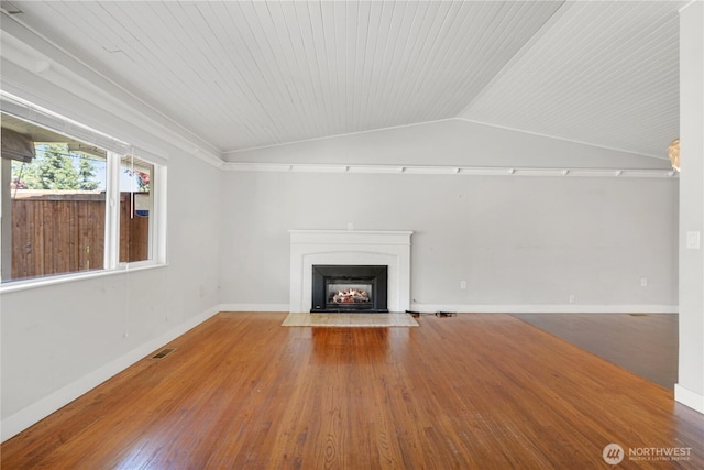 17004 11th Ave NE, Shoreline, WA 98155 - unfurnished living room featuring a fireplace with flush hearth, wood finished floors, lofted ceiling, baseboards, and wooden ceiling