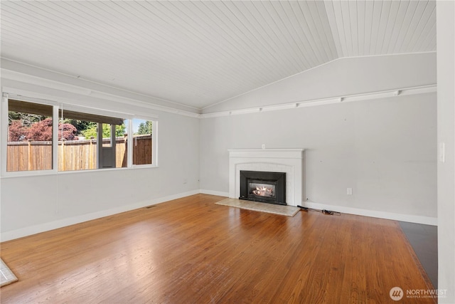 17004 11th Ave NE, Shoreline, WA 98155 - unfurnished living room with lofted ceiling, baseboards, wood finished floors, a brick fireplace, and wood ceiling