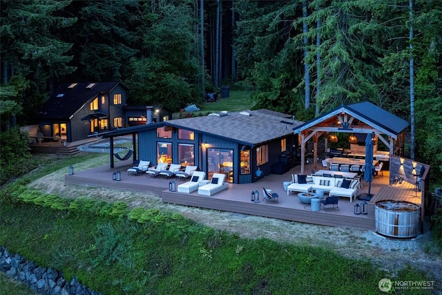 6570 E Grapeview Loop Rd, Allyn, WA 98524 - rear view of house with outdoor lounge area, a deck, a gazebo, and a shingled roof