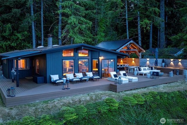 6570 E Grapeview Loop Rd, Allyn, WA 98524 - rear view of house featuring outdoor lounge area, a wooden deck, and a wooded view
