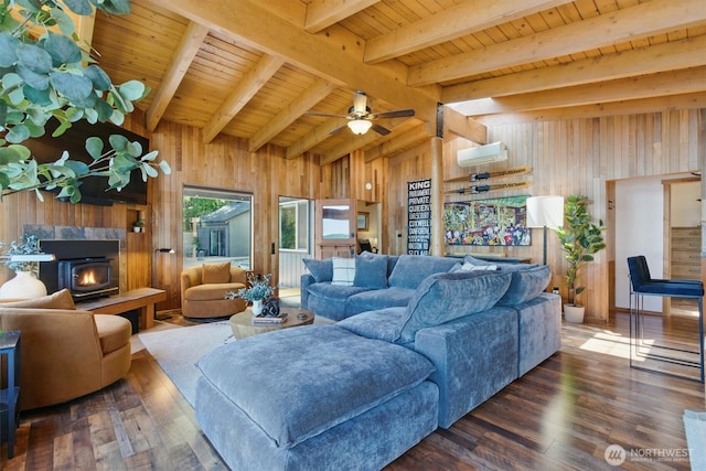 6570 E Grapeview Loop Rd, Allyn, WA 98524 - living area featuring wood walls, a wood stove, an AC wall unit, wood ceiling, and wood finished floors
