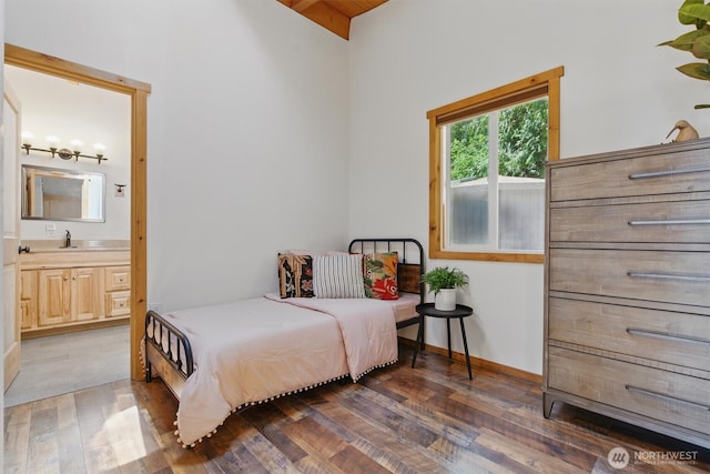 6570 E Grapeview Loop Rd, Allyn, WA 98524 - bedroom featuring light wood finished floors, ensuite bathroom, and a sink