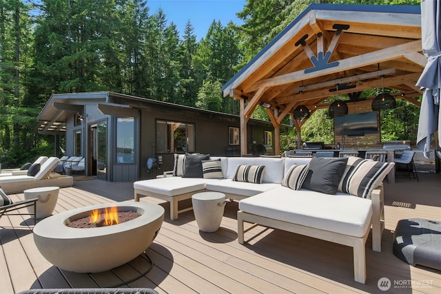 6570 E Grapeview Loop Rd, Allyn, WA 98524 - wooden terrace with an outdoor living space with a fire pit and a gazebo