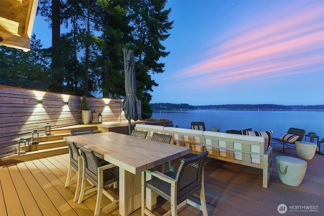 6570 E Grapeview Loop Rd, Allyn, WA 98524 - deck at dusk with a water view and outdoor dining space