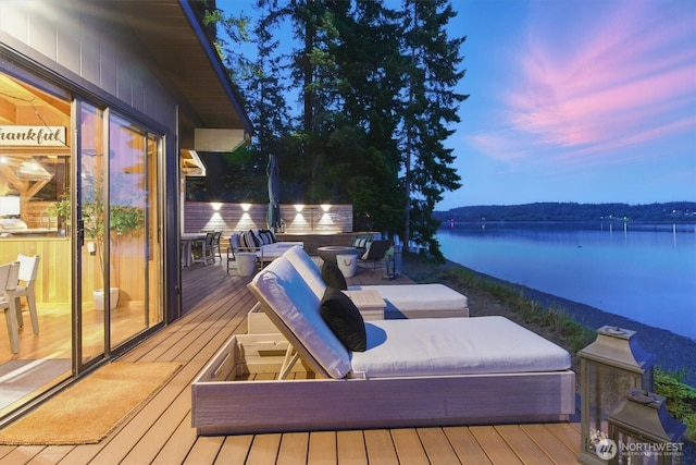 6570 E Grapeview Loop Rd, Allyn, WA 98524 - deck at dusk with a water view and an outdoor living space