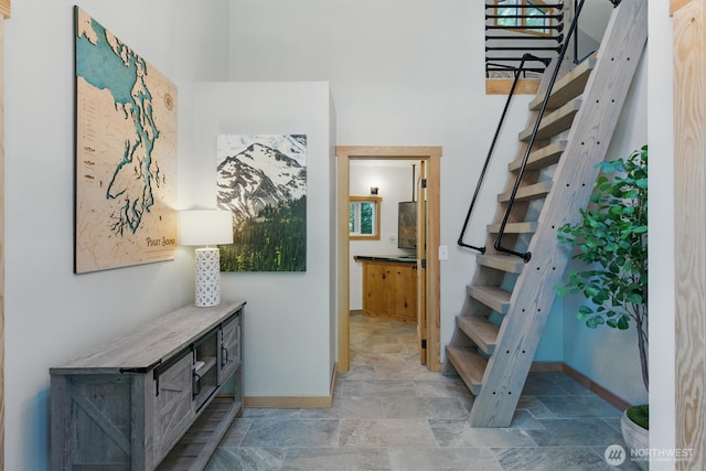 6570 E Grapeview Loop Rd, Allyn, WA 98524 - entrance foyer with stairs, stone finish flooring, and baseboards