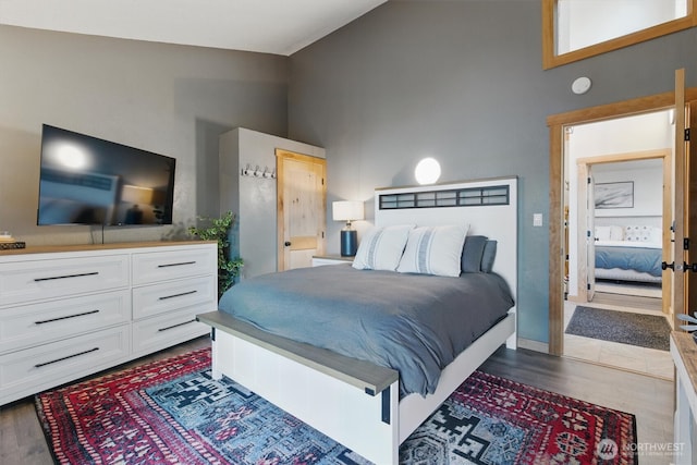 6570 E Grapeview Loop Rd, Allyn, WA 98524 - bedroom with dark wood-type flooring and high vaulted ceiling