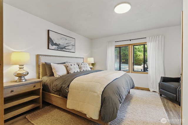 6570 E Grapeview Loop Rd, Allyn, WA 98524 - bedroom featuring wood finished floors and baseboards