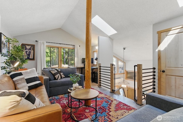 6570 E Grapeview Loop Rd, Allyn, WA 98524 - living area featuring a skylight, plenty of natural light, vaulted ceiling, and a textured ceiling