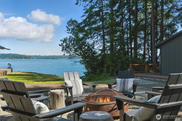 6570 E Grapeview Loop Rd, Allyn, WA 98524 - view of patio with an outdoor fire pit and a water view