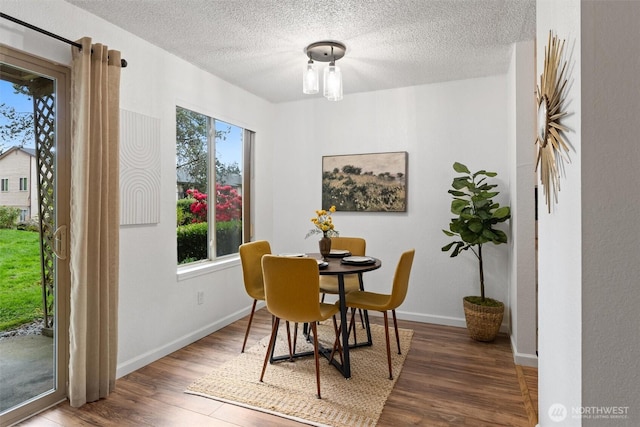 12515 NE 145th Pl Unit D121, Kirkland, WA 98034 - dining space featuring wood finished floors, baseboards, and a textured ceiling