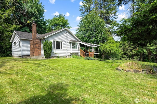 1627 SE Holman Rd, Port Orchard, WA 98367 - rear view of property with a yard and a deck
