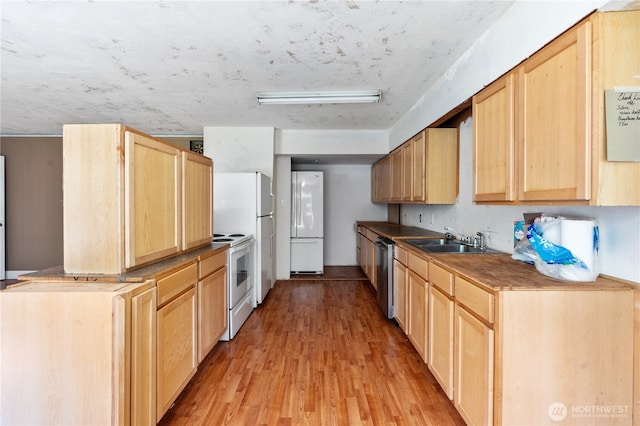 1627 SE Holman Rd, Port Orchard, WA 98367 - kitchen featuring white appliances, light brown cabinetry, a sink, and light wood-type flooring