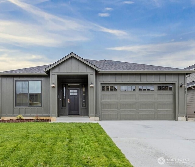 603 Cardinal Ave, Winlock, WA 98596 - view of front of property featuring board and batten siding, concrete driveway, a garage, and a front lawn