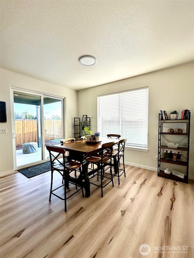 603 Cardinal Ave, Winlock, WA 98596 - dining room with light wood finished floors, a textured ceiling, and baseboards