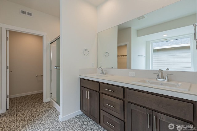603 Cardinal Ave, Winlock, WA 98596 - bathroom with a shower stall, double vanity, baseboards, and tile patterned floors