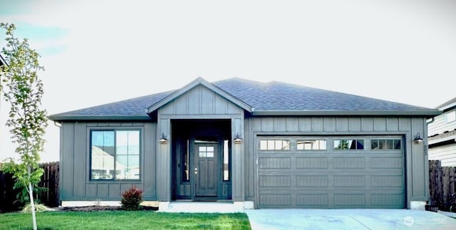 603 Cardinal Ave, Winlock, WA 98596 - view of front of house with a garage, driveway, a shingled roof, and board and batten siding