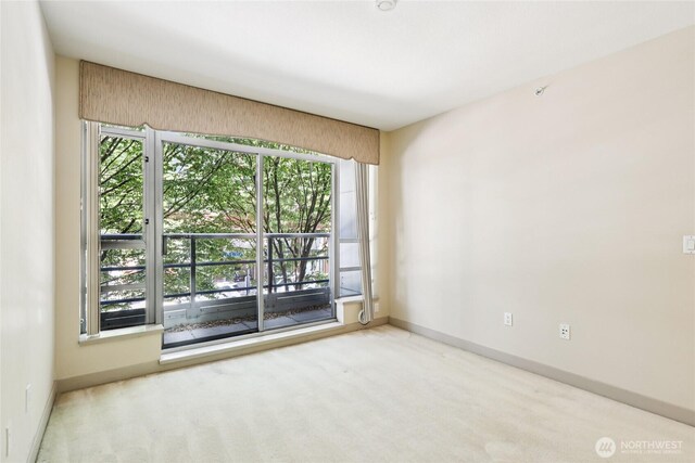 2929 1st Ave Unit 205, Seattle, WA 98121 - spare room featuring carpet floors and baseboards
