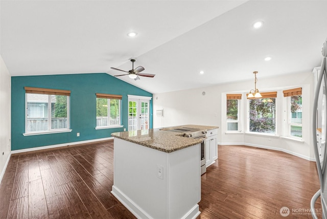 5937 Danials Loop SE, Lacey, WA 98513 - kitchen featuring dark wood finished floors, white cabinetry, stainless steel appliances, stone counters, and vaulted ceiling