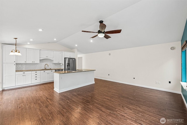 5937 Danials Loop SE, Lacey, WA 98513 - kitchen with stainless steel fridge with ice dispenser, lofted ceiling, white cabinetry, ceiling fan, and a kitchen island
