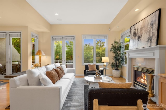 740 1st St S, Kirkland, WA 98033 - living area with french doors, plenty of natural light, wood finished floors, a fireplace, and recessed lighting