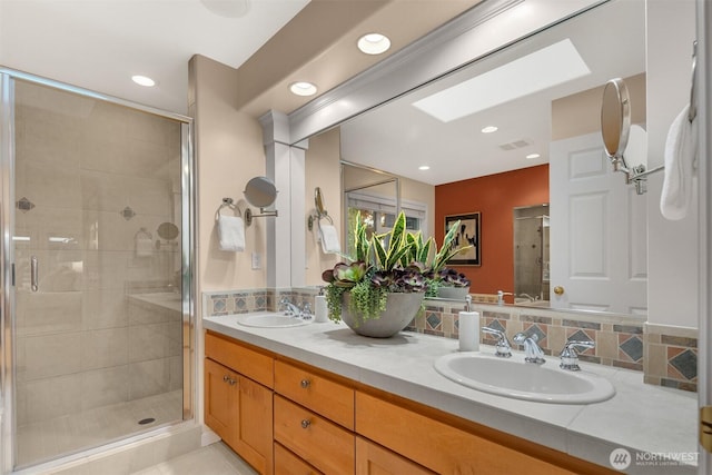 740 1st St S, Kirkland, WA 98033 - full bath featuring double vanity, a shower stall, recessed lighting, and a skylight