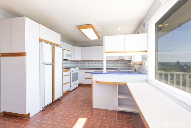 1001 S 226th St, Des Moines, WA 98198 - kitchen featuring white appliances, a sink, decorative backsplash, white cabinets, and brick patterned floors