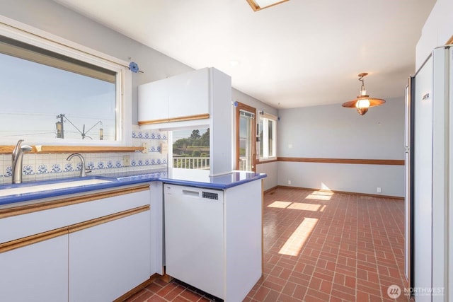 1001 S 226th St, Des Moines, WA 98198 - kitchen featuring white dishwasher, fridge, brick patterned flooring, and white cabinetry
