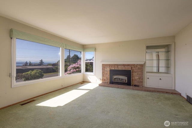 1001 S 226th St, Des Moines, WA 98198 - unfurnished living room featuring carpet, baseboards, and a stone fireplace