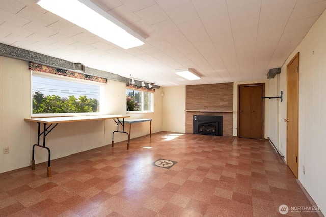 1001 S 226th St, Des Moines, WA 98198 - unfurnished living room with light flooring and a fireplace