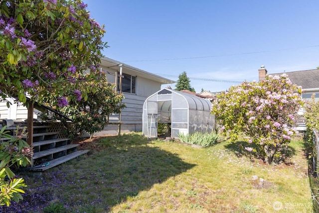 1001 S 226th St, Des Moines, WA 98198 - view of green lawn with a greenhouse and an outbuilding