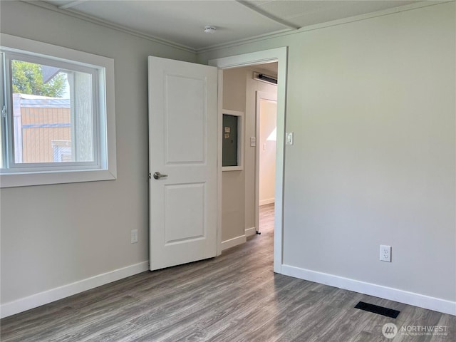 18501 52nd Ave W Unit 84, Lynnwood, WA 98037 - spare room with wood finished floors, ornamental molding, baseboards, a smoke detector, and electric panel