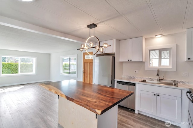 18501 52nd Ave W Unit 84, Lynnwood, WA 98037 - kitchen featuring appliances with stainless steel finishes, a sink, butcher block countertops, white cabinets, and light wood-style floors