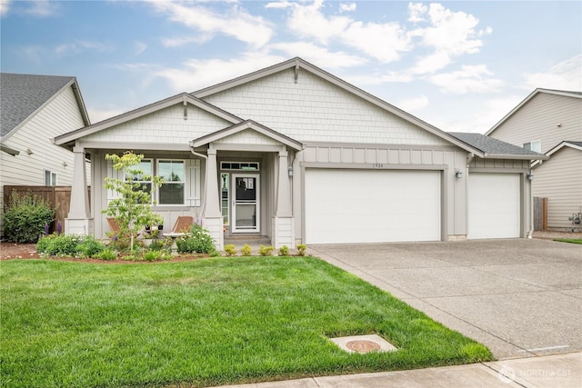 1924 Schneiter Dr, Longview, WA 98632 - view of front of home with board and batten siding, an attached garage, and driveway