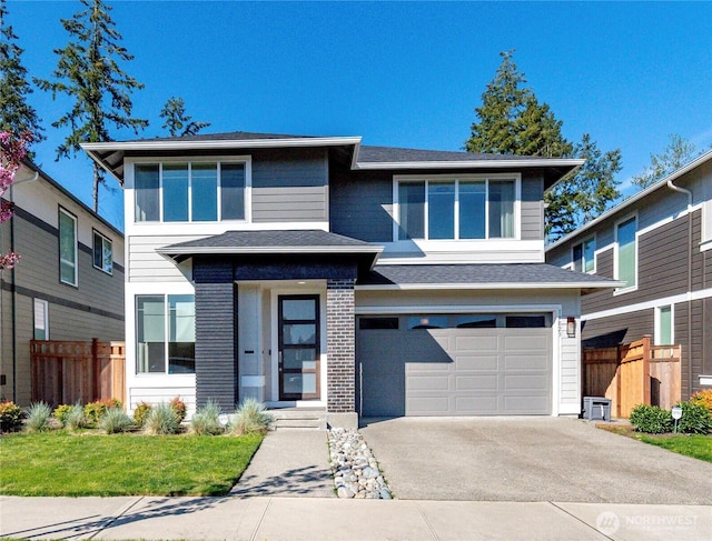 19023 131st Street Ct E, Bonney Lake, WA 98391 - prairie-style home featuring an attached garage, concrete driveway, and roof with shingles