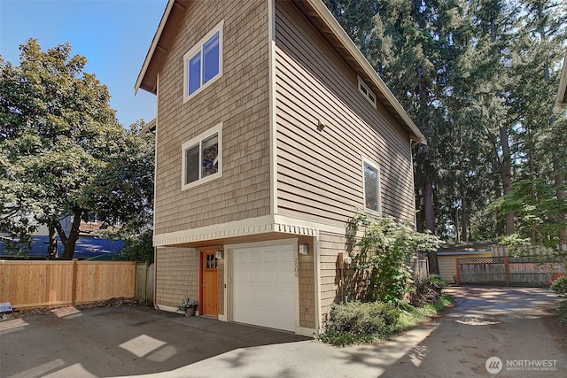 2509NE 125th St, Seattle, WA 98125 - view of side of property with an attached garage and concrete driveway