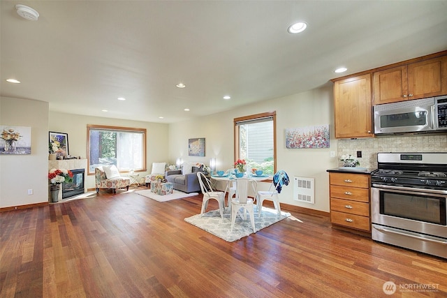 2509NE 125th St, Seattle, WA 98125 - kitchen featuring stainless steel appliances, open floor plan, recessed lighting, decorative backsplash, and wood finished floors