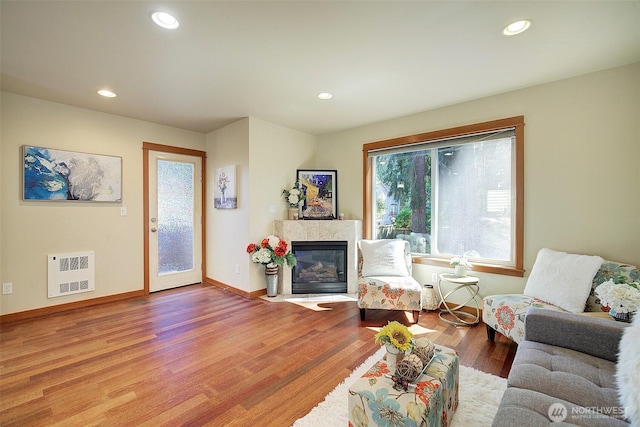 2509NE 125th St, Seattle, WA 98125 - living area with wood finished floors, a fireplace with flush hearth, recessed lighting, baseboards, and heating unit