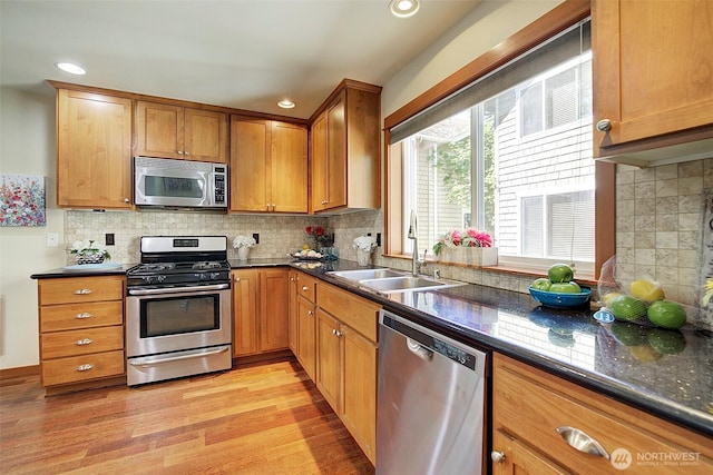 2509NE 125th St, Seattle, WA 98125 - kitchen featuring stainless steel appliances, a sink, light wood-type flooring, brown cabinets, and recessed lighting