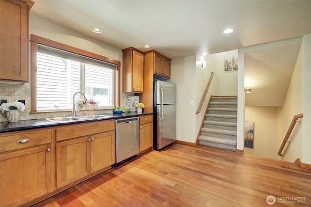 2509NE 125th St, Seattle, WA 98125 - kitchen with stainless steel appliances, a sink, dark countertops, light wood-style floors, and recessed lighting