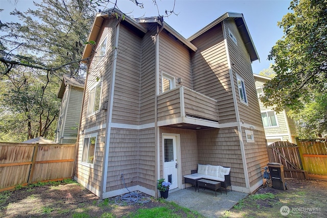 2509NE 125th St, Seattle, WA 98125 - back of property featuring a fenced backyard, a patio, and a gate
