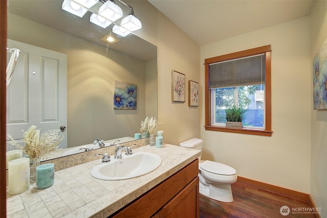 2509NE 125th St, Seattle, WA 98125 - bathroom featuring wood finished floors, toilet, vanity, and baseboards