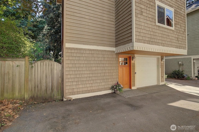 2509NE 125th St, Seattle, WA 98125 - view of property exterior featuring an attached garage and asphalt driveway