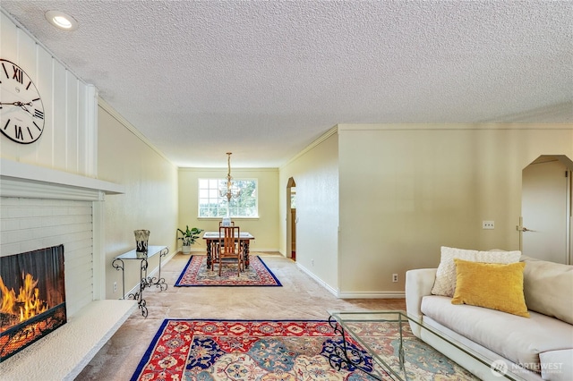 26421 Kingsview Loop NE, Kingston, WA 98346 - living room featuring arched walkways, ornamental molding, a textured ceiling, light carpet, and a chandelier